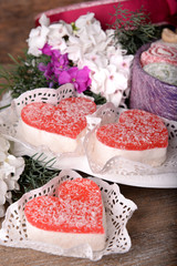 Sweets with flowers on wooden background