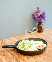 hot fried rice on wooden table serve on black pan