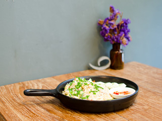 hot fried rice on wooden table serve on black pan