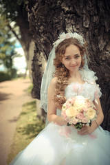 Portrait of beautiful bride in a park
