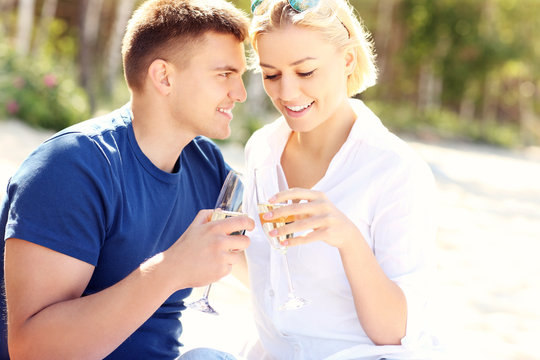 Romantic Couple With Champagne At The Beach