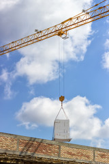 crane lifting stacked white styrofoam sheets 5