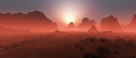 Red rocky desert landscape in the mist at sunset. Panoramic shot
