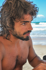 Young Male with long hair and Beard, latinamerican, Brazil beach