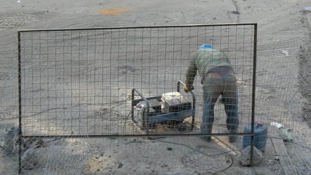 Worker launches engine of electrical generator