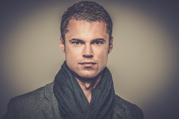 Obraz premium Handsome young man in casual jacket and neck scarf