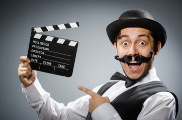 Funny man with movie clapper board