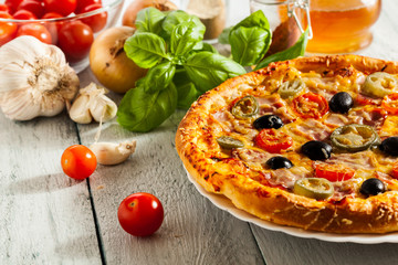 Pizza with bacon, olives and jalapeno pepper