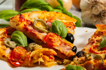Pizza with bacon, olives and jalapeno pepper