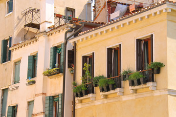 Fototapeta na wymiar Picturesque Italian house with flowers on the balconie