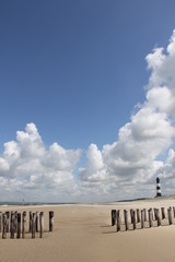 lighthouse and cumulus clouds Holland beach