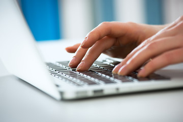 Closeup of businesswoman typing on laptop computer