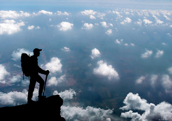 Man standing on summit of mountain.
