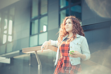 young beautiful hipster woman with red curly hair