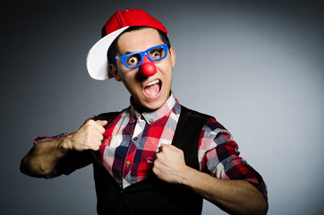 Funny clown against the dark background