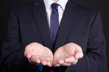business man holding hand presenting product