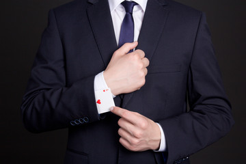 businessman with ace card hidden under sleeve - obrazy, fototapety, plakaty