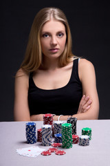 Fototapeta premium serious woman in casino with cards and chips