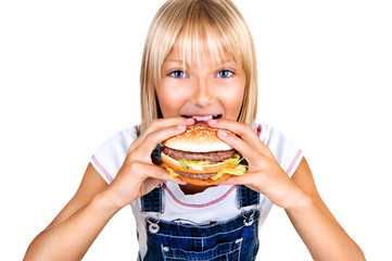 Pretty little girl eating a hamburger isolated on white