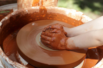 Hands on pottery wheel
