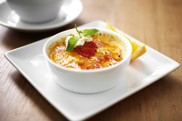close up egg custard and strawberry in white cup