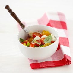 Caprese with red and yellow cherry tomatoes