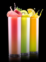 tasty summer fruits with juice in glass