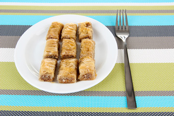 Sweet baklava on plate on table