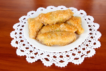 Sweet baklava on plate on table close-up