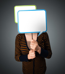 Young woman holding speech bubble