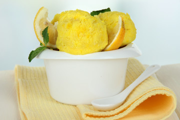 Tasty ice cream scoops in bowl, on table