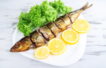Smoked fish on plate close up