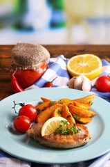 Grilled steak, grilled vegetables and fried potato pieces