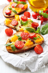 Tasty bruschetta with tomatoes, on table