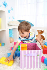 Cute little boy playing in room