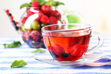 Fruit red tea with wild berries in glass cup,