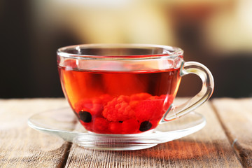 Fruit red tea with wild berries in glass cup,