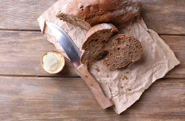 Fresh bread and homemade butter on wooden background