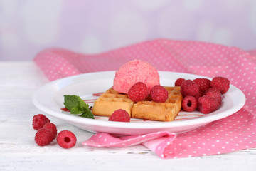 Tasty belgian waffles with ice cream on wooden table