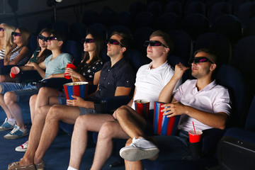 Young people watching movie in cinema