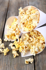 Popcorn on wooden table, close up
