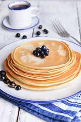 Sweet pancakes with berries on table close-up