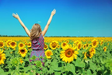 Acrylic prints Sunflower Young woman in sunflower field