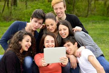 Group of young adults browsing a tablet