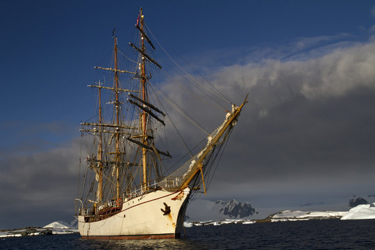 sailing ship on the background of the mountains of the Antarctic