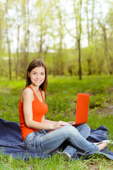 pretty girl with a computer in park