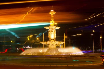 Papier Peint photo Fontaine Night Seville, the fountain and fires of passing cars