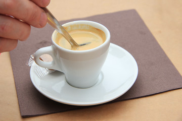 Man stiring an espresso