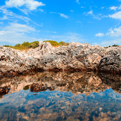 Fototapeta na wymiar square photo of rocks reflection in sea
