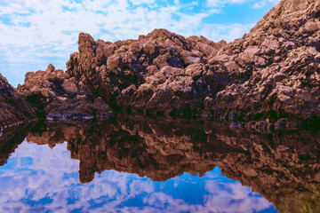 Fototapeta na wymiar Horizontal picture of rocks and their reflection in the sea
